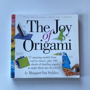 Origami books, paper, and folding board.
